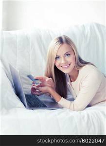 smiling businesswoman with laptop and credit card. businesswoman with laptop and credit card