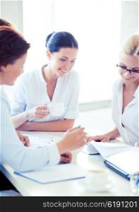 smiling businesswoman with team on meeting in office. businesswoman with team on meeting in office