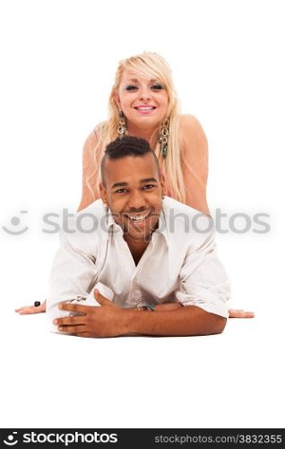 Smiling caucasian girl and black guy couple lying on the floor over white isolated background