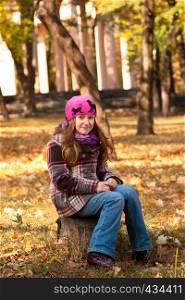 smiling child girl at the autumn park