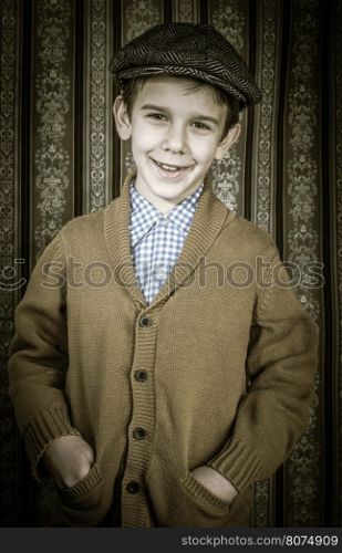 Smiling child in vintage clothes and hat. Close up shot