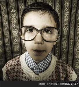 Smiling child with glasses in vintage clothes. Close up shot