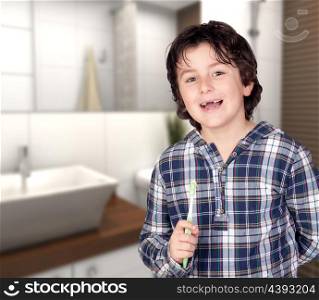 Smiling child without a toothbrush in the bathroom