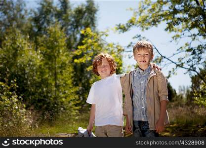 Smiling children hugging outdoors