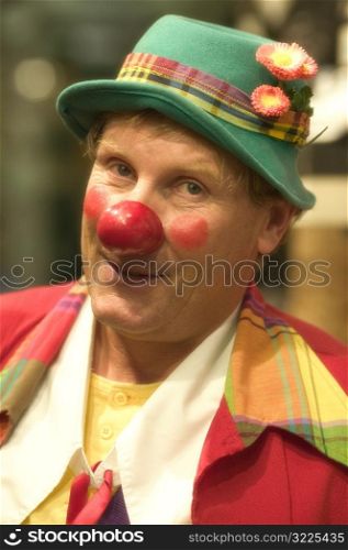 Smiling Clown Wearing A Green Hat