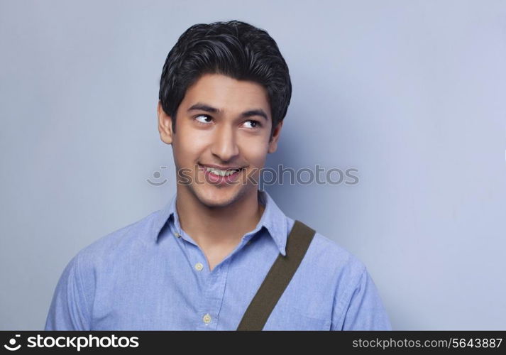 Smiling college student looking up