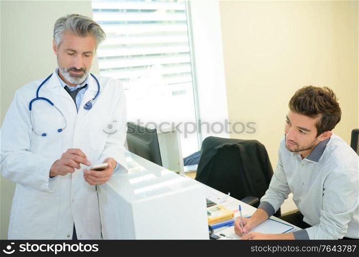 smiling confident doctor at the reception desk