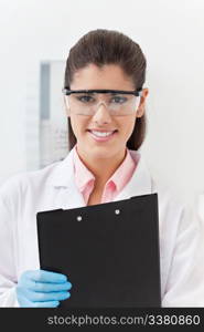 Smiling confident young dentist holding clipboard