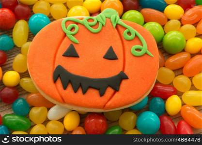 Smiling cookie pumpkin on many candy colors