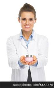 Smiling cosmetologist doctor woman showing bottle of creme