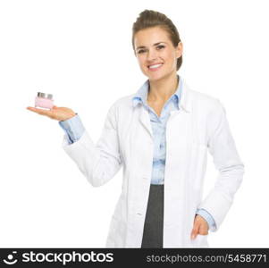 Smiling cosmetologist woman showing cream bottle