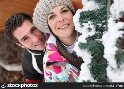 smiling couple and Christmas tree