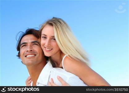 Smiling couple at the beach in summer