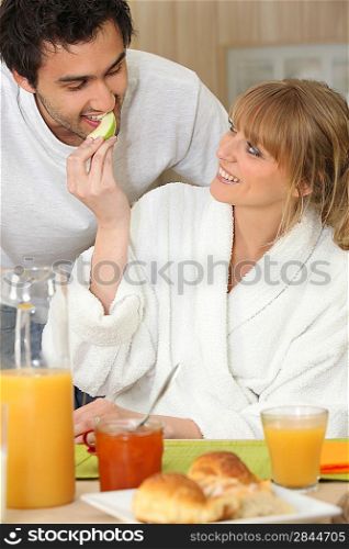 Smiling couple breakfasting