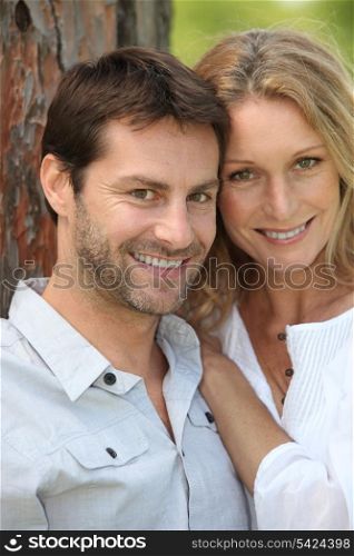 Smiling couple by tree