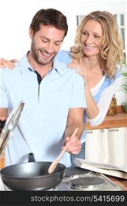 Smiling couple cooking