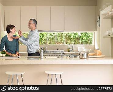 Smiling couple cooking together