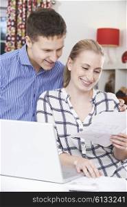 Smiling Couple Discussing Domestic Finances At Home