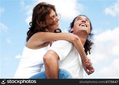 Smiling couple enjoying piggyback ride
