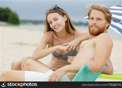 smiling couple holding hands on the beach