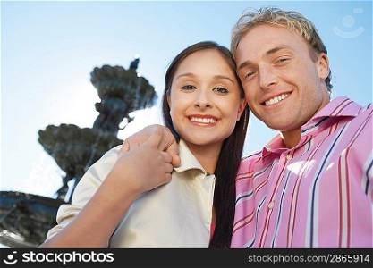 Smiling Couple in Front of Fountain