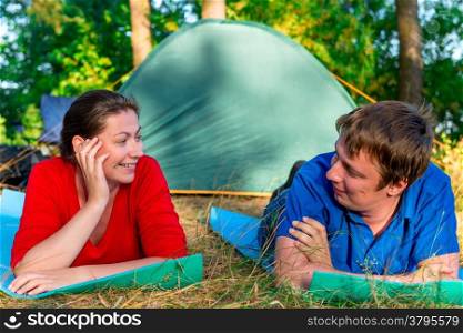 smiling couple in love posing next to the tent