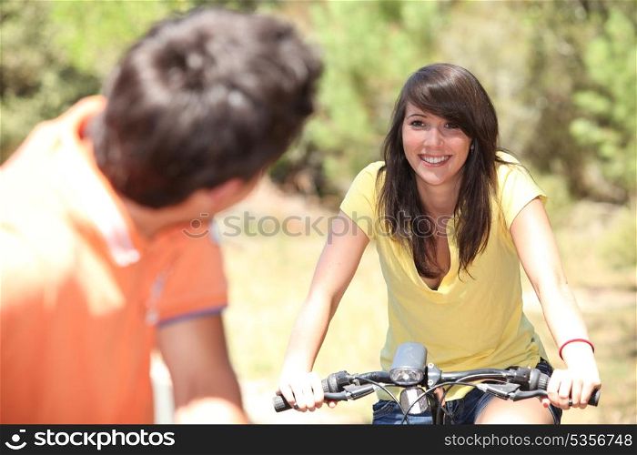 Smiling couple on a bicycle
