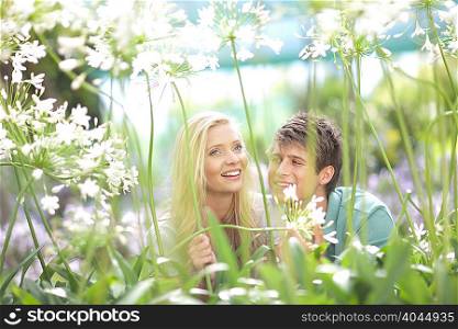 Smiling couple walking in tall plants