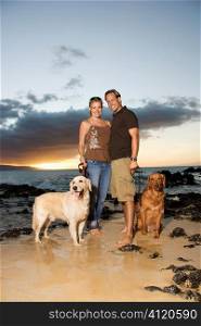 Smiling Couple With Dogs at the Beach