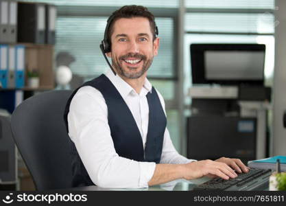 smiling customer support operator with hands-free headset