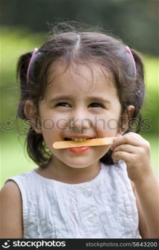 Smiling cute girl holding candy stick