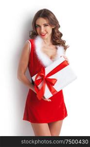 Smiling cute girl in red christmas outfit holding gift box on white background. Girl with christmas gift box