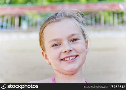 Smiling cute girl with blond hair and blue eyes