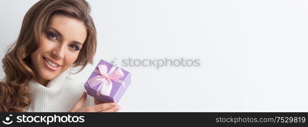 Smiling cute girl with pink christmas gift box. Girl with christmas gift box