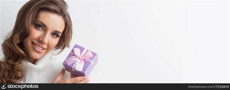 Smiling cute girl with pink christmas gift box. Girl with christmas gift box