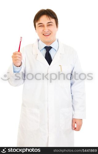 Smiling dentist holding toothbrush in hand isolated on white&#xA;
