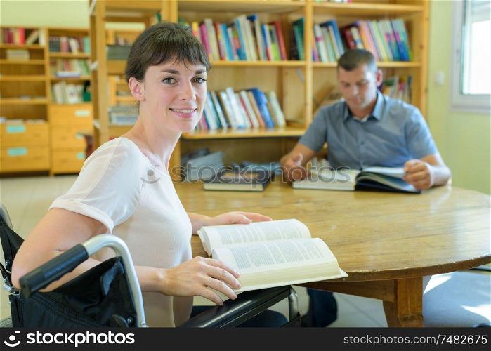 smiling disabled student in library