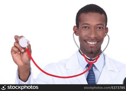 Smiling doctor holding aloft his stethoscope