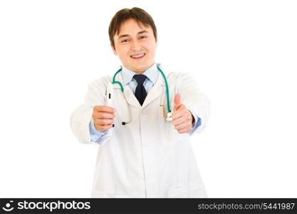 Smiling doctor holding medical thermometer and showing thumbs up gesture isolated on white&#xA;