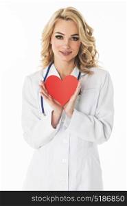 Smiling doctor holding paper heart. Smiling female doctor holding heart shape paper studio portrait isolated on white background