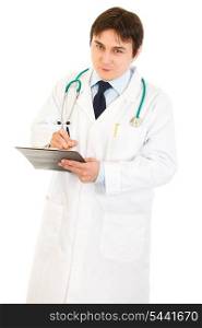 Smiling doctor with stethoscope making notes in medical chart isolated on white&#xA;