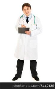 Smiling doctor with stethoscope making notes in medical chart isolated on white&#xA;
