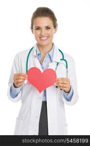 Smiling doctor woman holding heart shape paper