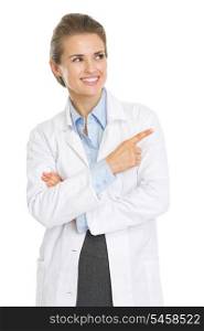Smiling doctor woman pointing on copy space