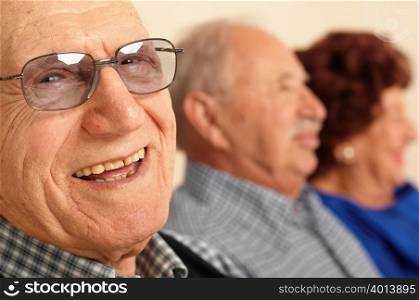 Smiling elderly man in foreground