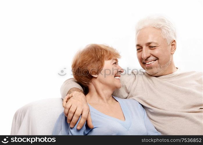 Smiling elderly pair on a white background