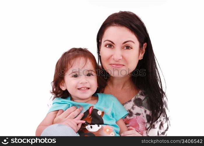 Smiling embracing mom and daughter looking at camera
