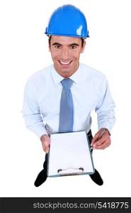 Smiling engineer holding a blank clipboard