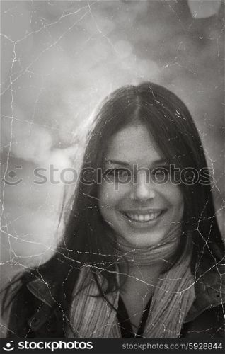 Smiling face of pretty brunette retro photo stylization.