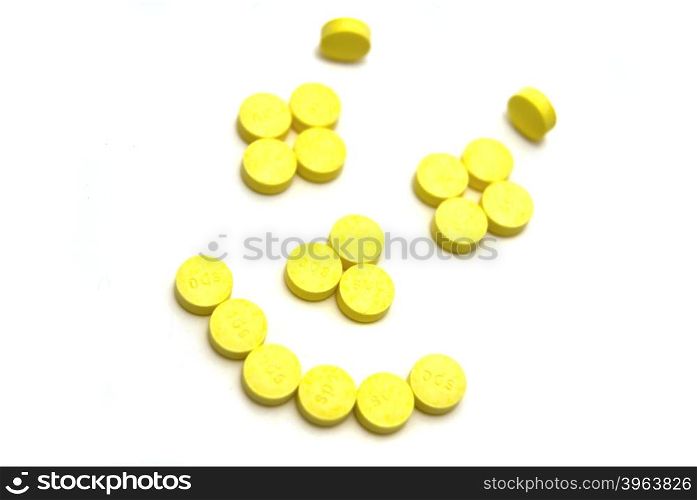 Smiling face pills on white background